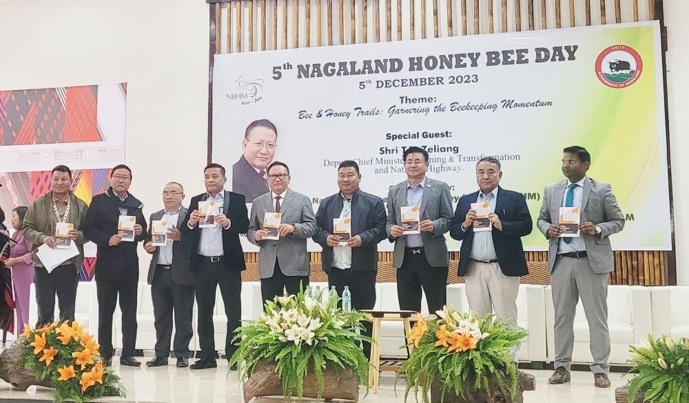 TR Zeliang and others during the release of book on award winners’ stories during the 5th Nagaland Honey Bee Day at Kisama on December 5. (Morung Photo)