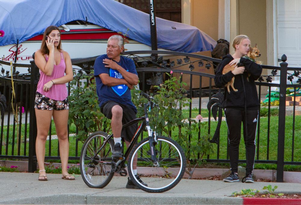 People look on from near the scene of a mass shooting during the Gilroy Garlic Festival in Gilroy, California, U.S. July 28, 2019. REUTERS/Chris Smead