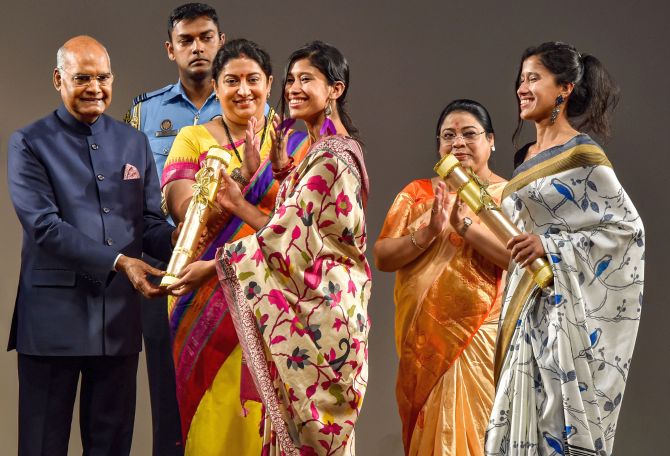Mountaineers Tashi Malik and Nungshi Malik receive 'Nari Shakti Puraskar 2019' on International Women's Day from President Ram Nath Kovind as Union Minister Smriti Irani looks on, at Rashtrapati Bhavan Cultural Center in New Delhi, Sunday, March 8, 2020. The Malik sisters became the first twin sister to conquer Mount Everest in 2013 and are holders of 6 Guinness World Record. (PTI Photo/Manvender Vashist