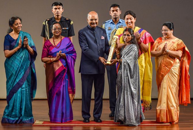 Bina Devi receives 'Nari Shakti Puraskar 2019' on International Women's Day from President Ram Nath Kovind as First Lady Savita Kovind, Union Ministers Smriti Irani and Nirmala Sitharaman look on, at Rashtrapati Bhavan Cultural Center in New Delhi, Sunday, March 8, 2020. Devi who is fondly known as 'Mushroom Mahila' for popularizing mushroom cultivation, has trained farmers on mushroom farming, organic farming, vermin-compost production, organic insecticide preparation at home. (PTI Photo/Manvender Vashist)
