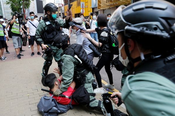 Anti-government demonstrators scuffle with riot police during a lunch time protest as a second reading of a controversial national anthem law takes place in Hong Kong, China on May 27, 2020. (REUTERS Photo)