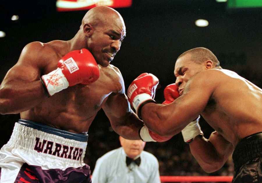 WBA Heavyweight Champion Evander Holyfield (R) connects to the jaw of challenger Mike Tyson in the first round of their title fight June 28. (Reuters File Photo)