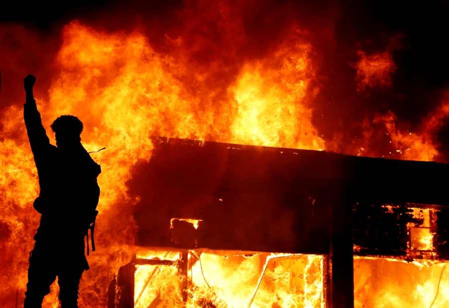 A protester gestures in front of a fire during a demonstration against the death in Minneapolis police custody of African-American man George Floyd, in Minneapolis, Minnesota, U.S., early May 30, 2020. (Reuters Photo)