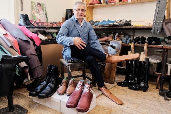 Romanian shoemaker Grigore Lup poses for a portrait while showcasing a pair of his long-nosed leather shoes to help keeping social distance, amid the outbreak of the coronavirus disease (COVID-19), in Cluj-Napoca, Romania on May 29. (REUTERS Photo)