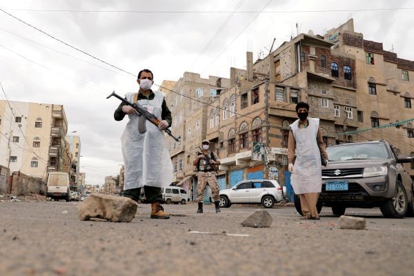 Security men wearing protective masks stand on a street during a 24-hour curfew amid concerns about the spread of the coronavirus disease (COVID-19), in Sanaa, Yemen on May 6, 2020. (REUTERS File Photo)