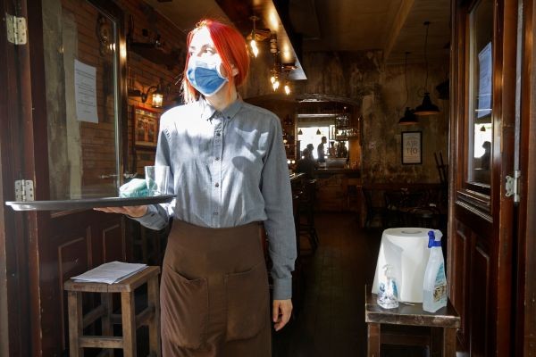 A waitress stands next to disinfectants after Prime Minister Dusko Markovic declared the country the coronavirus disease (COVID-19)-free in Podgorica, Montenegro on May 25, 2020. (REUTERS Photo)