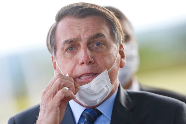 Brazil's President Jair Bolsonaro adjusts his mask as he leaves Alvorada Palace, amid the coronavirus disease (COVID-19) outbreak in Brasilia, Brazil on May 13, 2020. (REUTERS File Photo)