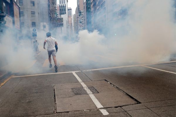 An anti-government protester runs away from tear gas during a march against Beijing's plans to impose national security legislation in Hong Kong, China on May 24. (REUTERS Photo)