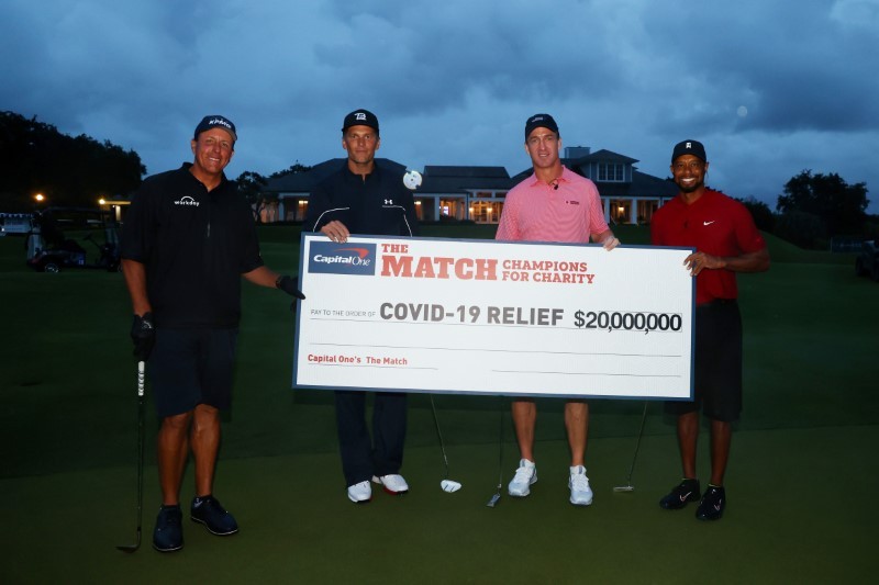 Tiger Woods and former NFL player Peyton Manning celebrate defeating Phil Mickelson and NFL player Tom Brady of the Tampa Bay Buccaneers on the 18th green during The Match: Champions for Charity golf round at the Medalist Golf Club. (Getty Images for The Match via USA TODAY Sports/REUTERS)