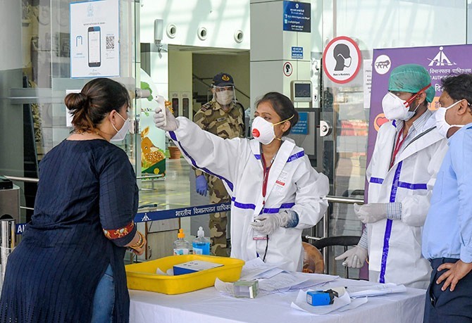 A passenger undergoes thermal screening at Raja Bhoj Airport in Bhopal. Photograph: PTI Photo