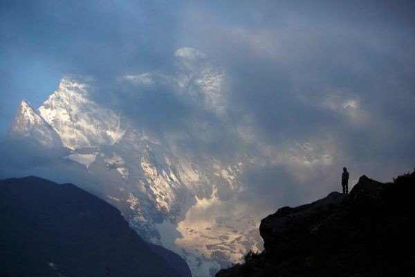 File picture of a Nepali Sherpa silhouetted as he stands in front of Mount Kongde, approximately 3400 meters above sea level, in Nepal's Everest region. (REUTERS File Photo)