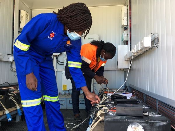 Employees charge lithium ion batteries for a Hamba electric motorcycle at a solar-powered recharging station in Wedza, Zimbabwe on 22 May 2020. (REUTERS File Photo)