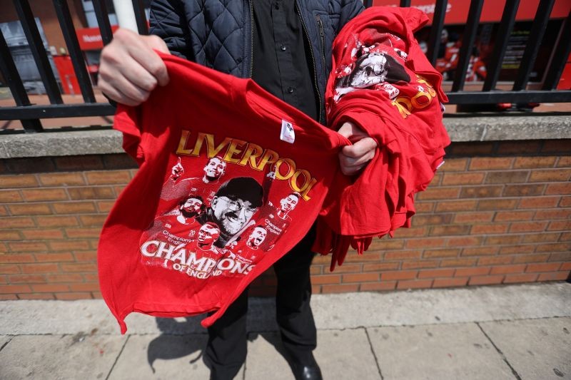 "Liverpool Champions of England" t-shirts are seen for sale after Liverpool were crowned Premier League champions last night after Chelsea won their match against Manchester City Action Images via Reuters/Carl Recine