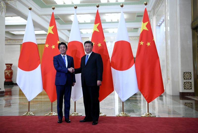 Japan's Prime Minister Shinzo Abe shakes hands with China's President Xi Jinping at the Great Hall of the People in Beijing, China on December 23, 2019. (REUTERS File Photo)