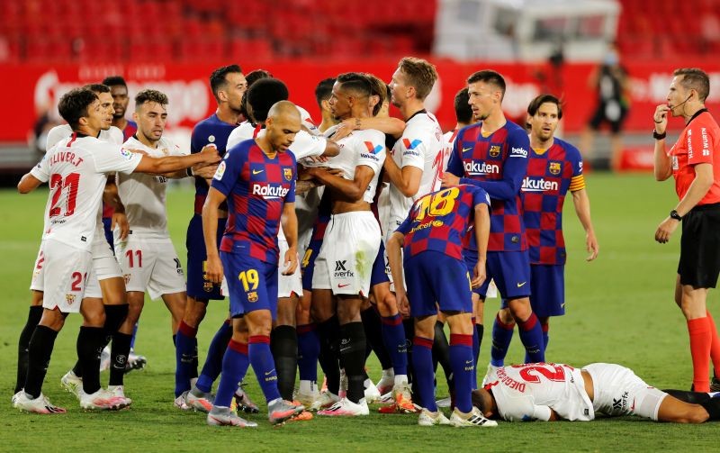 Players clash as Sevilla's Diego Carlos reacts after sustaining an injury, as play resumes behind closed doors following the outbreak of the coronavirus disease (COVID-19) REUTERS/Marcelo Del Pozo