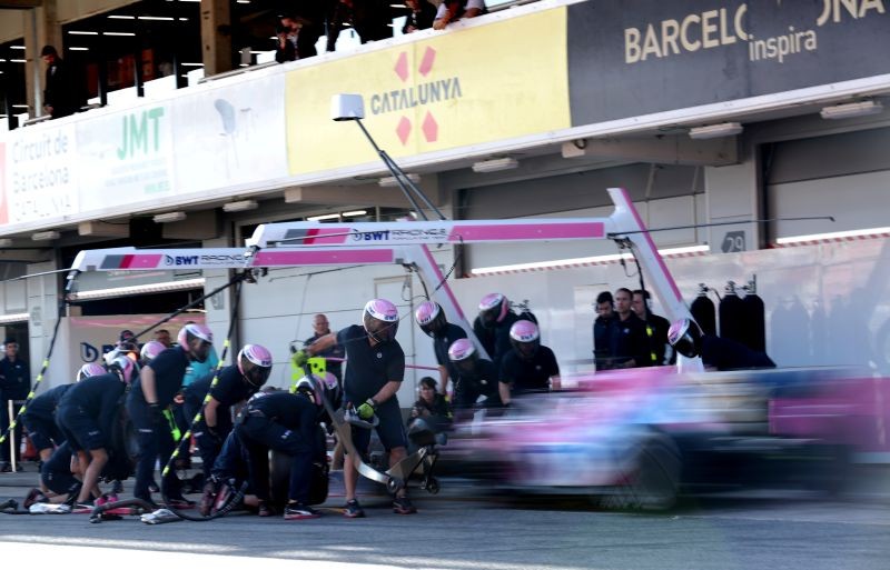 Engineers practice a pit stop on Racing Point's Sergio Perez during testing REUTERS/Albert Gea/File Photo