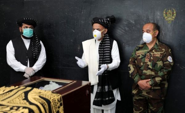 Afghanistan's President Ashraf Ghani (C) speaks over the coffin of Ayaz Niazi, a well-known scholar, who was killed last night by a bomb blast in Kabul, Afghanistan on June 3, 2020. (REUTERS Photo)