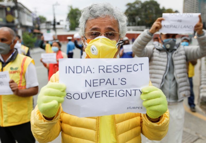 Activists affiliated with 'Human Rights and Peace Society Nepal' holding placards protest against the alleged encroachment of Nepal's border by India in the far west of Nepal, near the Indian Embassy in Kathmandu, Nepal May 12, 2020. REUTERS/Navesh Chitrakar/File Photo