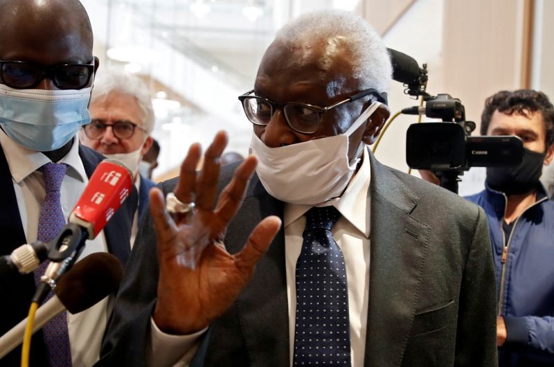 FILE PHOTO: Former President of the International Association of Athletics Federations (IAAF) Lamine Diack, wearing a face mask, gestures as he arrives for his trial at the Paris courthouse, France, June 8, 2020. REUTERS/Gonzalo Fuentes/File Photo