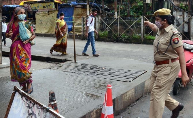 A female police personnel asking a woman to stay at home following the lockdown in Fancy Bazaar in Guwahati. Photograph: ANI Photo