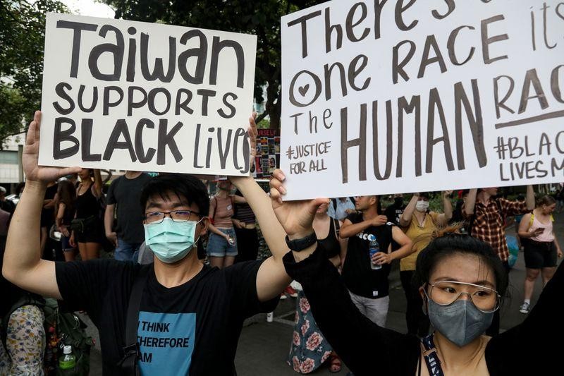 People hold posters supporting the Black Lives Matter movement in Taipei, Taiwan, June 13, 2020. REUTERS/Ann Wang
