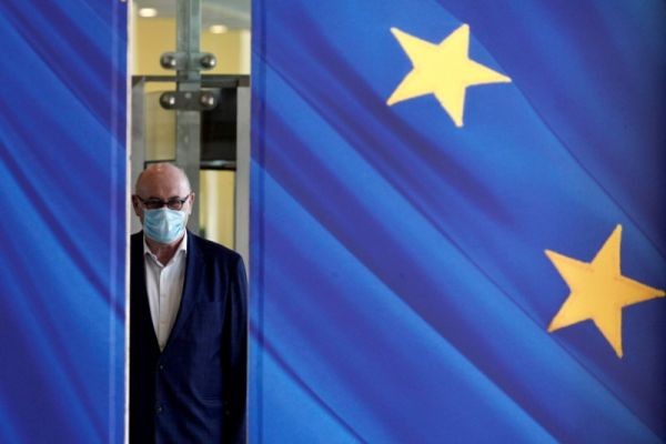 A man wearing a face mask walks past the European Commission headquarters as the spread of coronavirus disease (COVID-19) continues in Brussels, Belgium on May 14, 2020. (REUTERS File Photo)