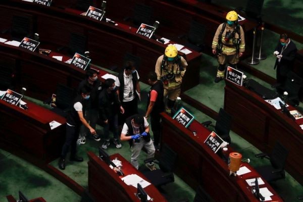 The police take photos at the chamber of the Legislative Council after pro-democracy lawmakers hurled objects during third reading on the controversial national anthem bill in Hong Kong, China on June 4, 2020. (REUTERS Photo)