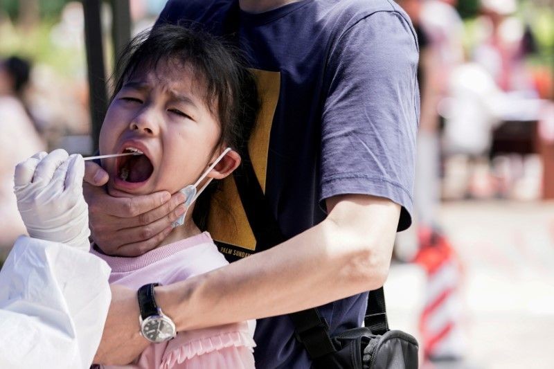 A child reacts while undergoing nucleic acid testing in Wuhan, the Chinese city hit hardest by the coronavirus disease (COVID-19) outbreak, Hubei province, China on May 16, 2020. (REUTERS File Photo)