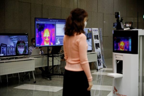 A self-driving robot checks the body temperature of an employee during its demonstration at the headquarters of SK Telecom in Seoul, South Korea on May 26, 2020. (REUTERS File Photo)