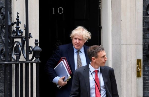 Britain's Prime Minister Boris Johnson and a personal protection officer leave 10 Downing Street, following the outbreak of the coronavirus disease (COVID-19), London, Britain on June 3, 2020. (REUTERS Photo)