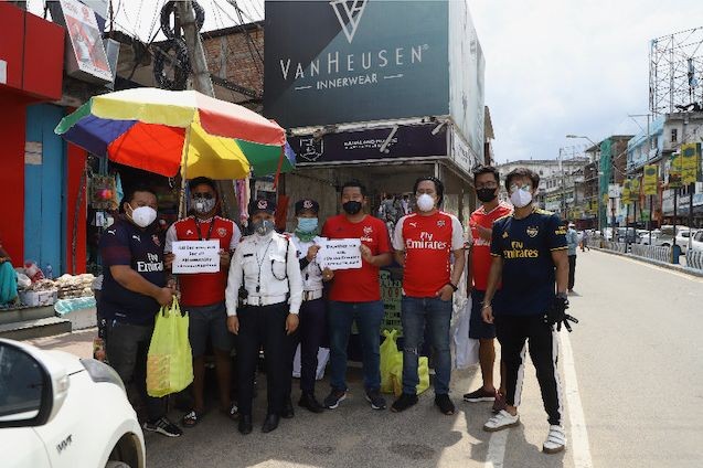 Members of the Arsenal Supporters Club Nagaland handing out refreshments to frontline workers in Dimapur on June 1.