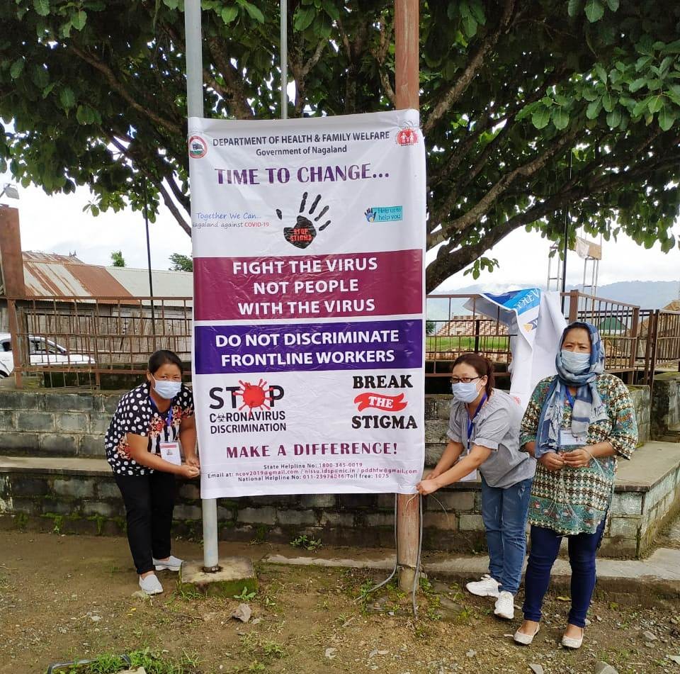 IEC team paste banners on preventive measures and stigma on COVID-19 at strategic places of Phek Town to create awareness among the public.
