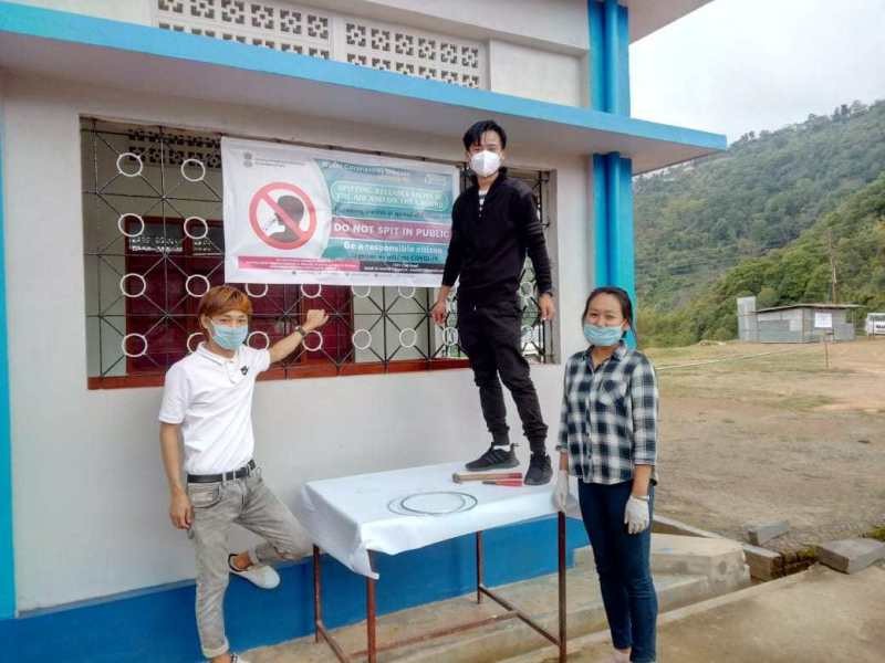 Awareness banners being put up at a quarantine center in Phek.