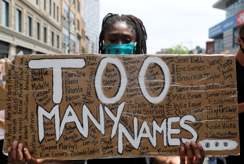 A demonstrator holds a placard during a protest against racial inequality in the aftermath of the death in Minneapolis police custody of George Floyd, in Brooklyn, New York, US on June 6. (REUTERS Photo)