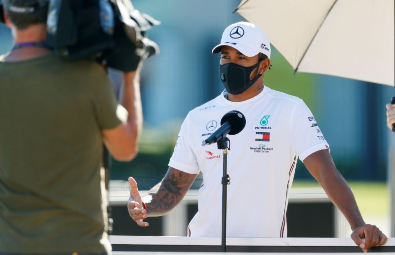 Formula One F1 - British Grand Prix - Silverstone Circuit, Silverstone, Britain - July 30, 2020 Mercedes' Lewis Hamilton talks to the media as he wears a protective face mask in the paddock ahead of the British Grand Prix REUTERS/Andrew Boyers