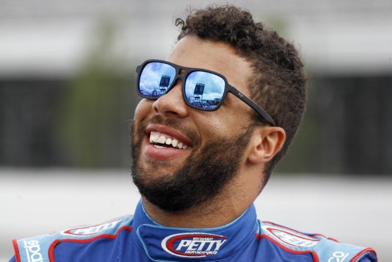 Bubba Wallace smiles from pit row prior to the Pocono Organics 325 at Pocono Raceway. (Reuters Photo)