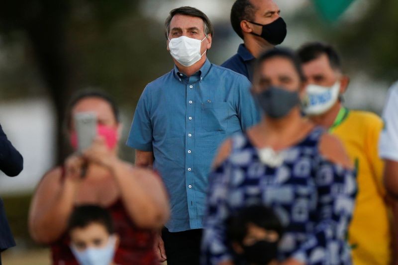 Brazil's President Jair Bolsonaro looks on while meeting supporters during a ceremony of lowering the national flag for the night, amid the coronavirus disease (COVID-19) outbreak, at the Alvorada Palace in Brasilia, Brazil on July 23, 2020. (REUTERS Photo)