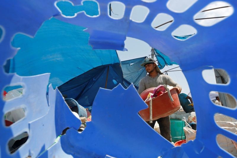 A Palestinian worker sorts plastic items collected to be recycled in a factory in the northern Gaza Strip on July 13, 2020. (REUTERS Photo)