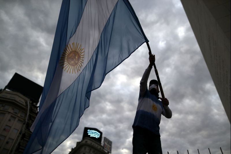A demonstrator waves an Argentine flag during a protest against the state takeover of agro exporter Vicentin and against COVID-19 quarantine measures in Buenos Aires, Argentina on June 20, 2020. (REUTERS File Photo)
