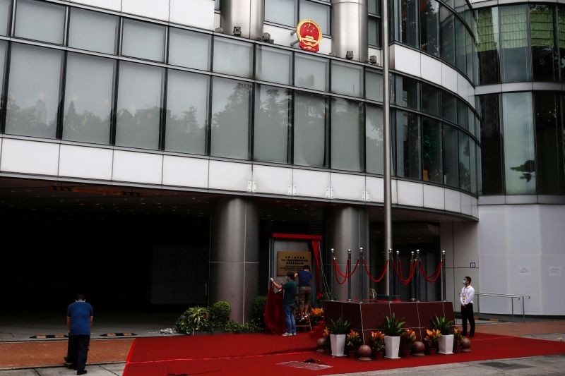 Workers work on a board after the opening of temporary national security office, in Hong Kong, China on July 8. (REUTERS Photo)