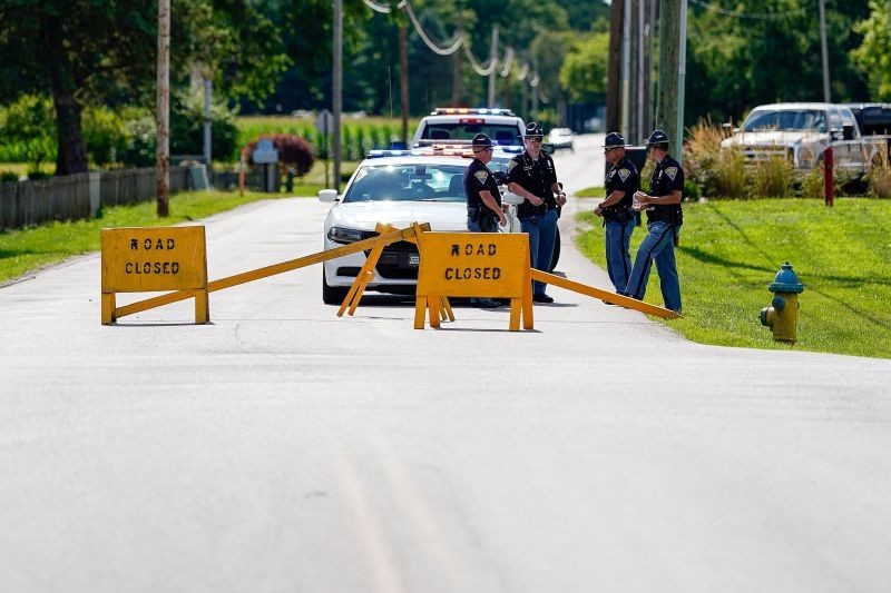 Indiana State Troopers block a road leading to the Federal Correctional Institution, Terre Haute, as officials await word about the stay of execution issued for Daniel Lewis Lee, who is convicted in the killing of three members of an Arkansas family in 1996, and would be the first federal execution in 17 years at the United States Penitentiary in Terre Haute, Indiana, US on July 13, 2020.  (REUTERS  Photo)