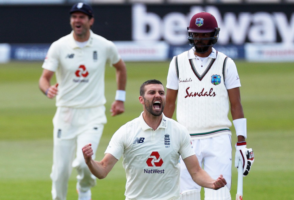 England's Mark Wood celebrates taking the wicket of West Indies' Shai Hope, as play resumes behind closed doors following the outbreak of the coronavirus disease (COVID-19) Adrian Dennis/Pool via REUTERS