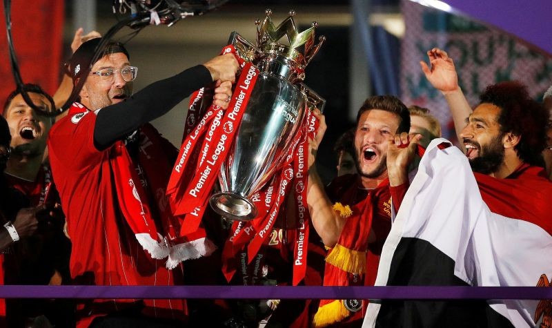 Liverpool manager Juergen Klopp, Adam Lallana and Mohamed Salah celebrate with the trophy after winning the Premier League Pool via REUTERS/Phil Noble