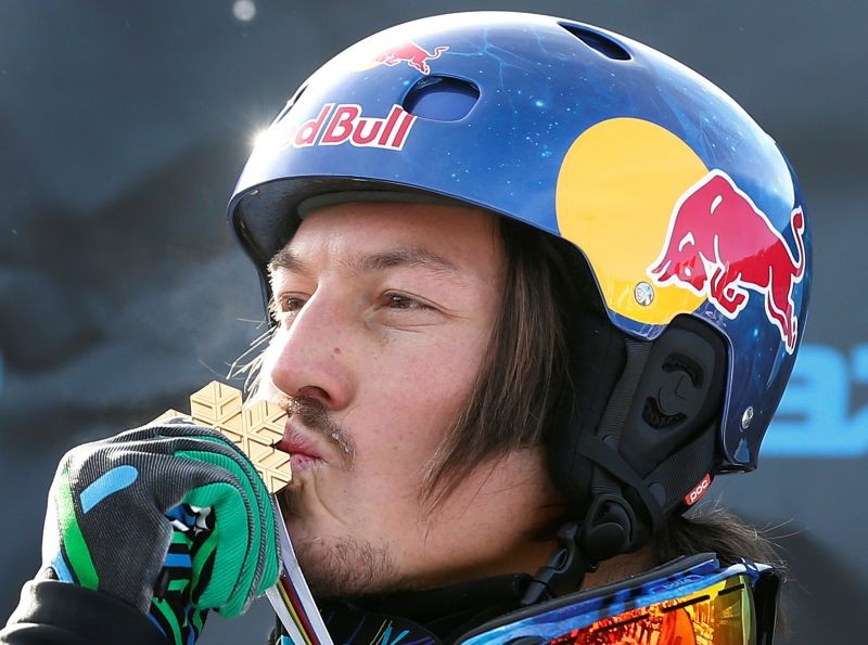 Australia's Alex Pullin kisses his medal on the podium after the men's snowboard-Cross finals at the FIS Snowboard World Championships in Stoneham, Quebec, Jan. 26, 2013, after winning the competition. REUTERS/Mathieu Belanger/File Photo