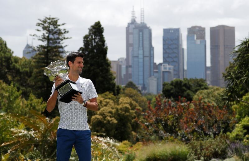 Australian Open champion Serbia's Novak Djokovic poses with the trophy during a photo shoot at the Royal Botanic Gardens Victoria. REUTERS/Issei Kato/File Photo