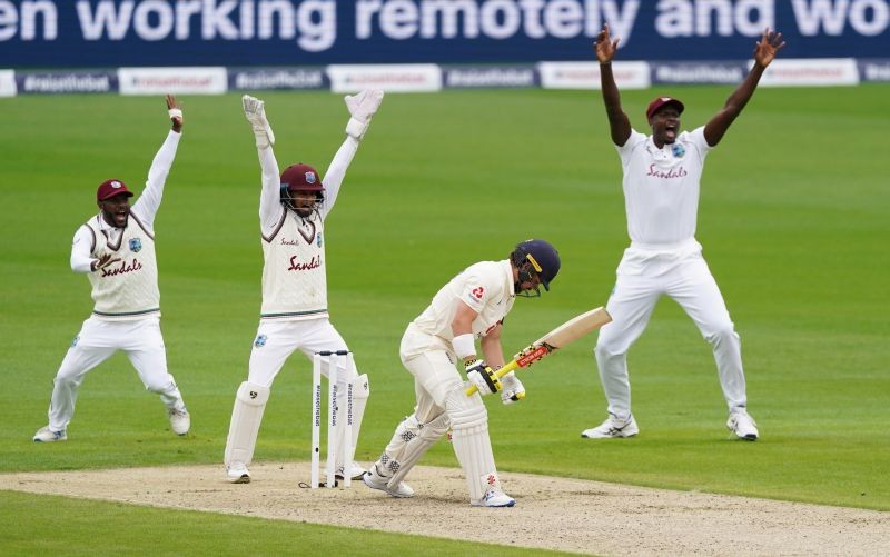England's Rory Burns reacts as he loses his wicket for LBW while West Indies' Jason Holder and teammates celebrate, as play resumes behind closed doors following the outbreak of COVID-19 on July 16. (Reuters Photo)