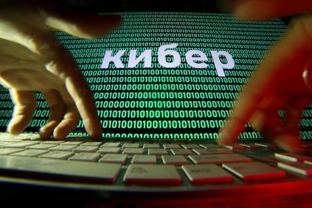 Hands are seen on a keyboard in front of a displayed cyber code in this picture illustration taken October 4, 2018. REUTERS/Dado Ruvic/Illustration/File Photo