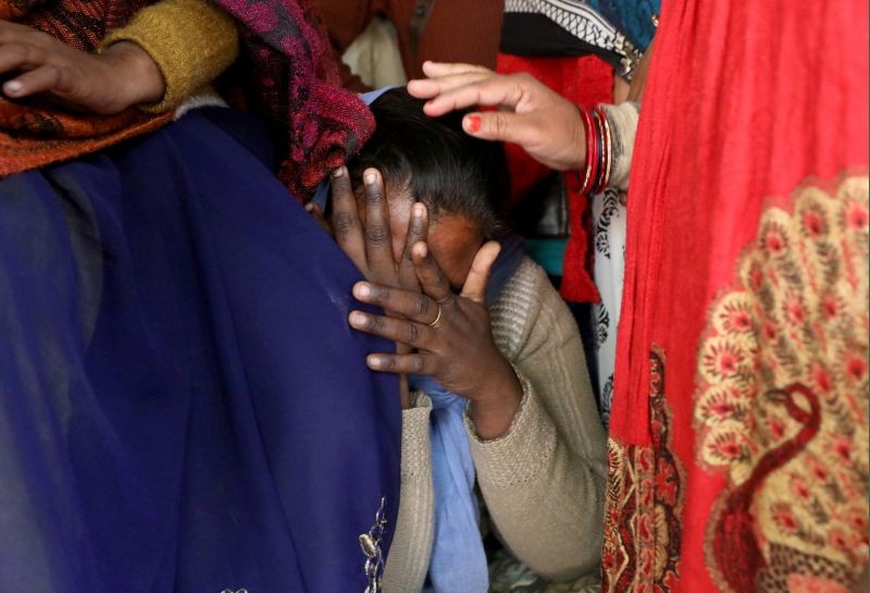 A relative of a 23-year-old rape victim, who died in a New Delhi hospital on Friday after she was set on fire by a gang of men, which included her alleged rapists, is consoled as she mourns the death of the victim outside a house in Unnao in the northern state of Uttar Pradesh on December 7, 2019. (REUTERS File Photo)