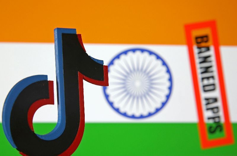 A 3d printed Tik Tok logo is seen in front of a displayed Indian flag and a "Banned app" sign in this illustration picture taken July 2, 2020. REUTERS/Dado Ruvic/Illustration