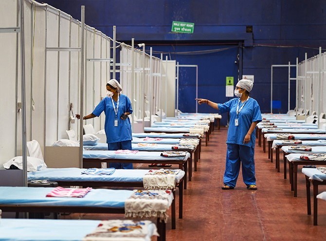 Health workers during preparation work at CWG Village COVID centre near Akshardham in New Delhi. Photograph: Vijay Verma/PTI Photo